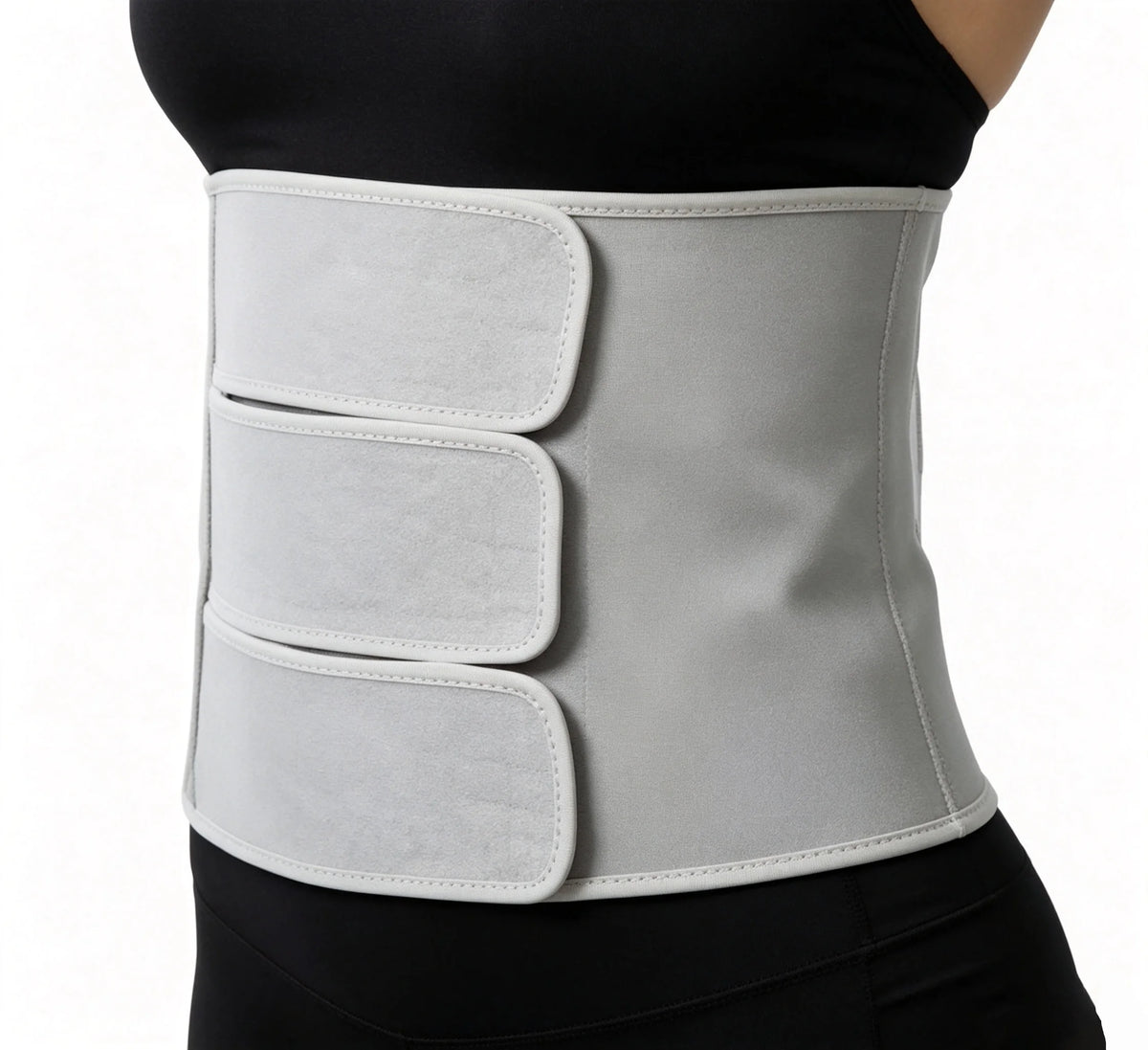 Postpartum abdominal binder worn low across the hips, three adjustable straps