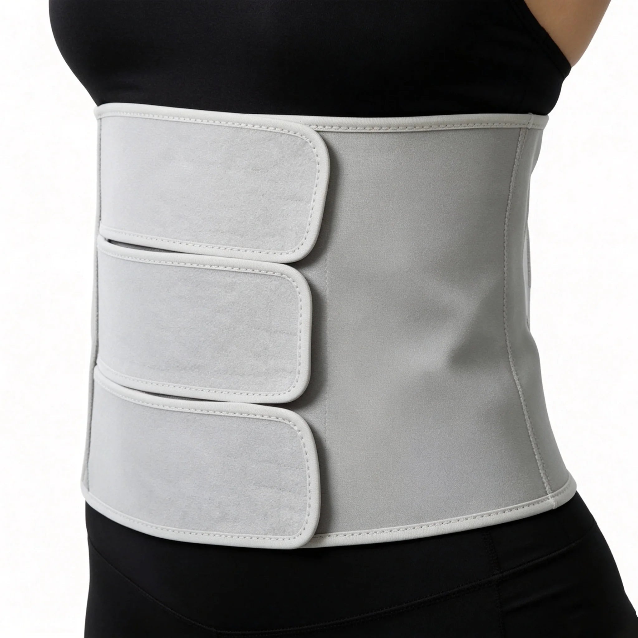 Postpartum abdominal binder worn low across the hips, three adjustable straps